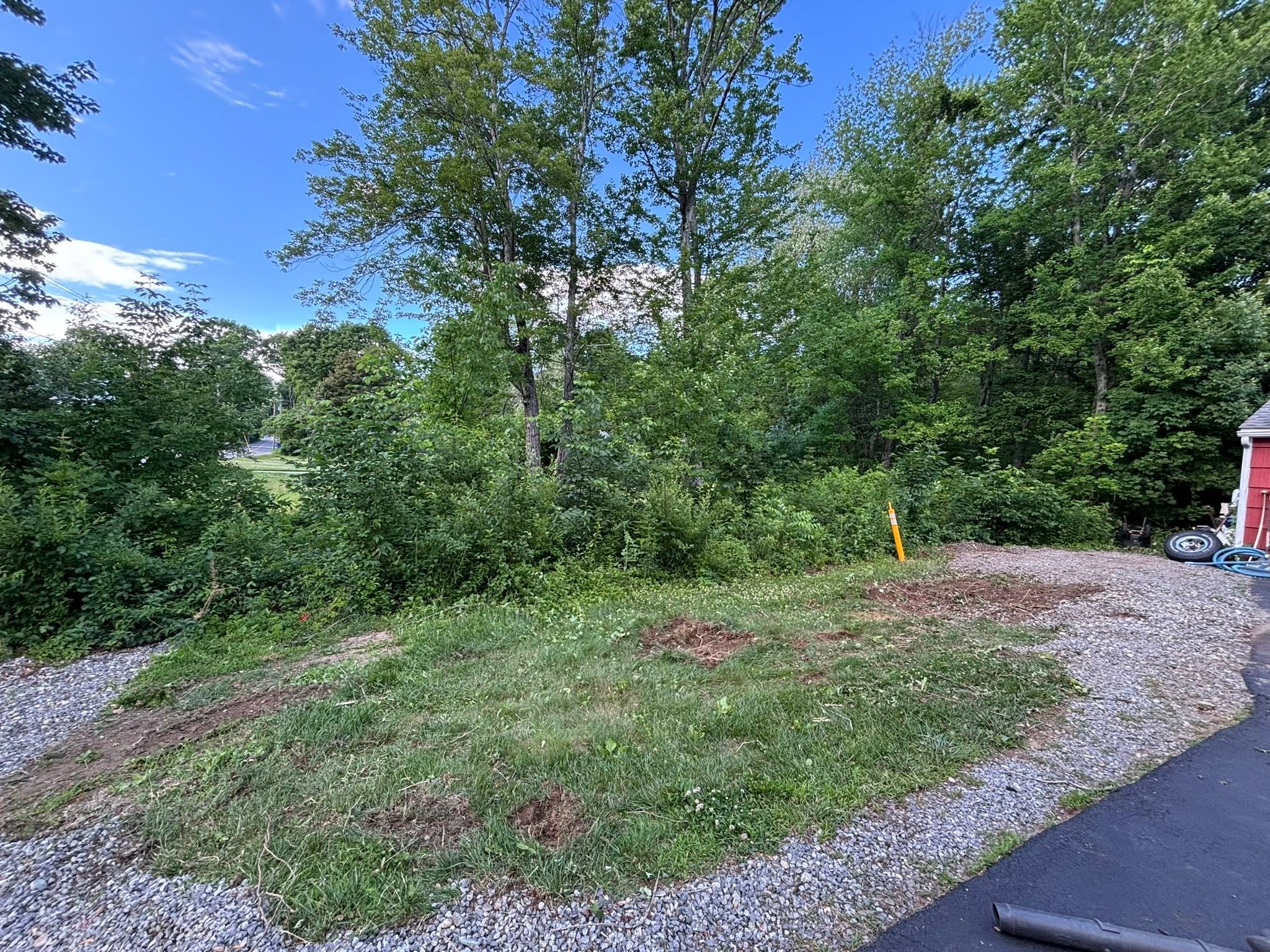 Debris hauled off-site, ground cleaned and graded